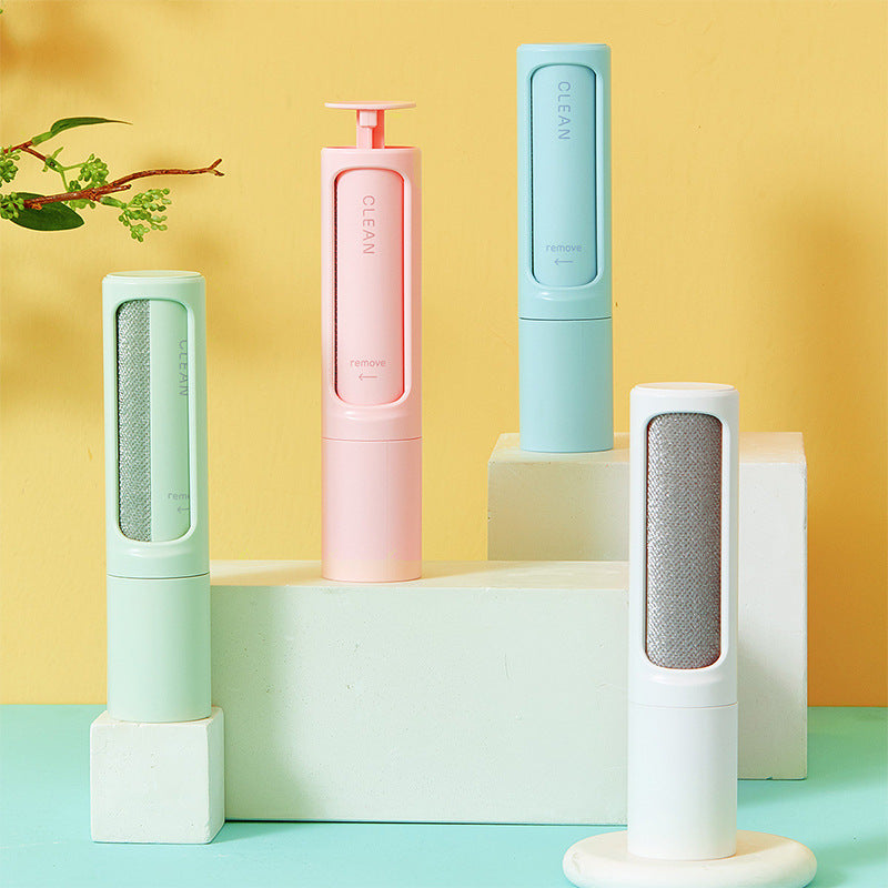 Four cylindrical cleaning products in pastel colors on a geometric platform with a yellow and blue gradient background.