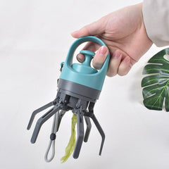 Hand holding a blue and gray tool with plant roots on a white background