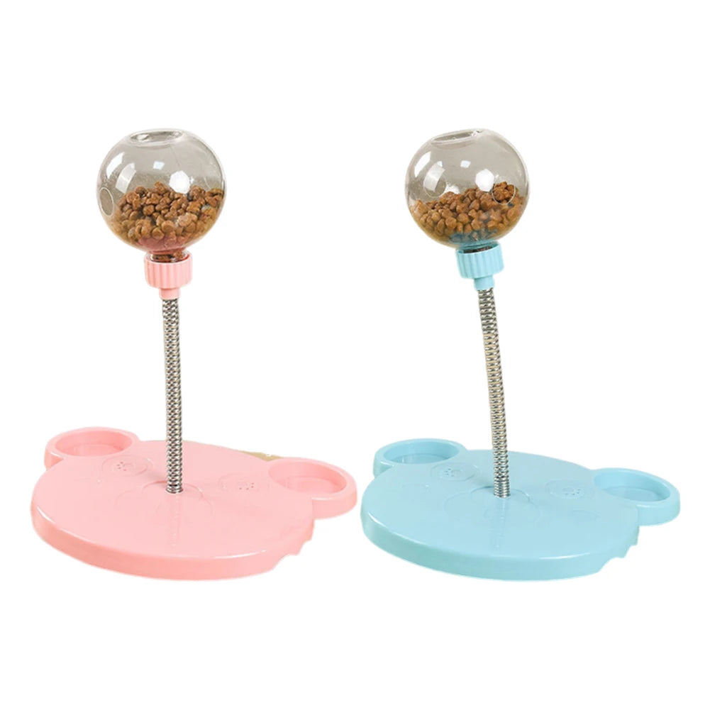 Two pet toys with transparent balls containing treats on pink and blue bases.