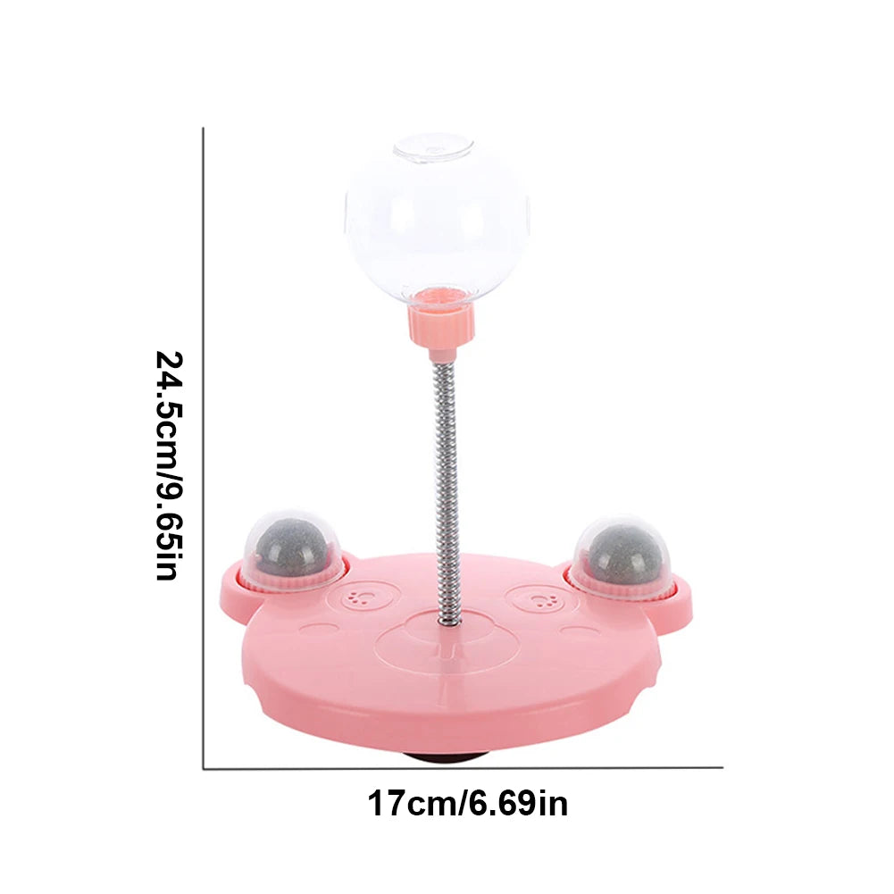 Pink toy with a stand and spherical components, showing measurements on a white background.
